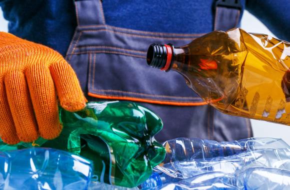 Worker wearing gloves sorting plastics